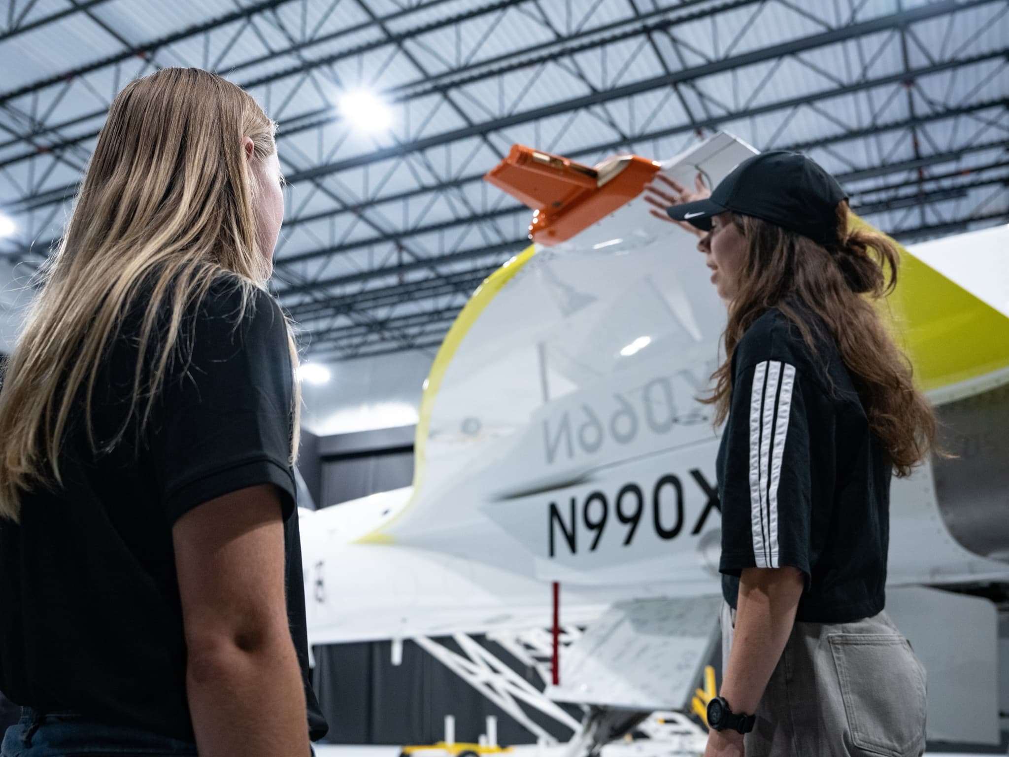 An intern who returned full-time explains the FEZ device on XB-1's wing to current interns