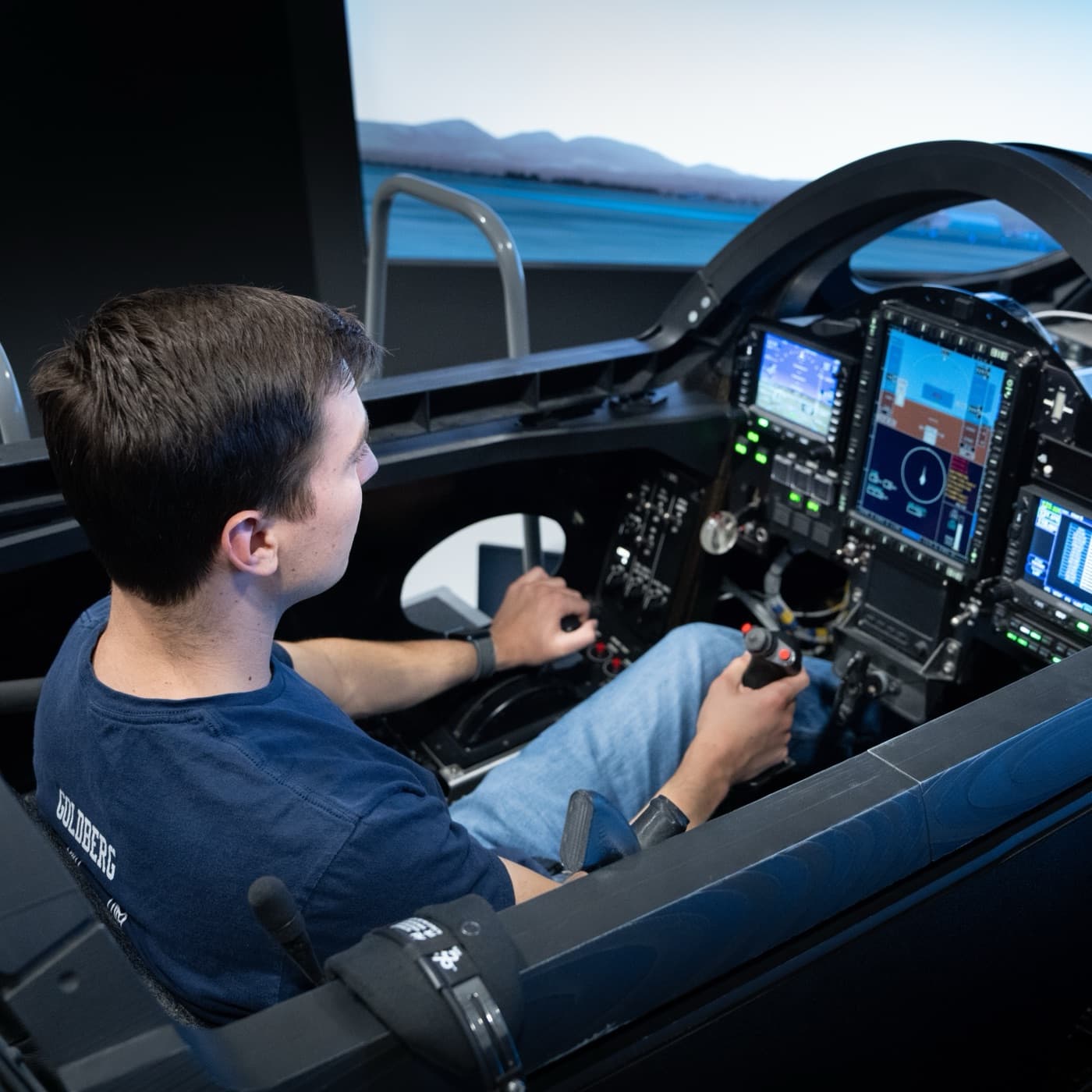 An intern at the controls of the XB-1 simulator