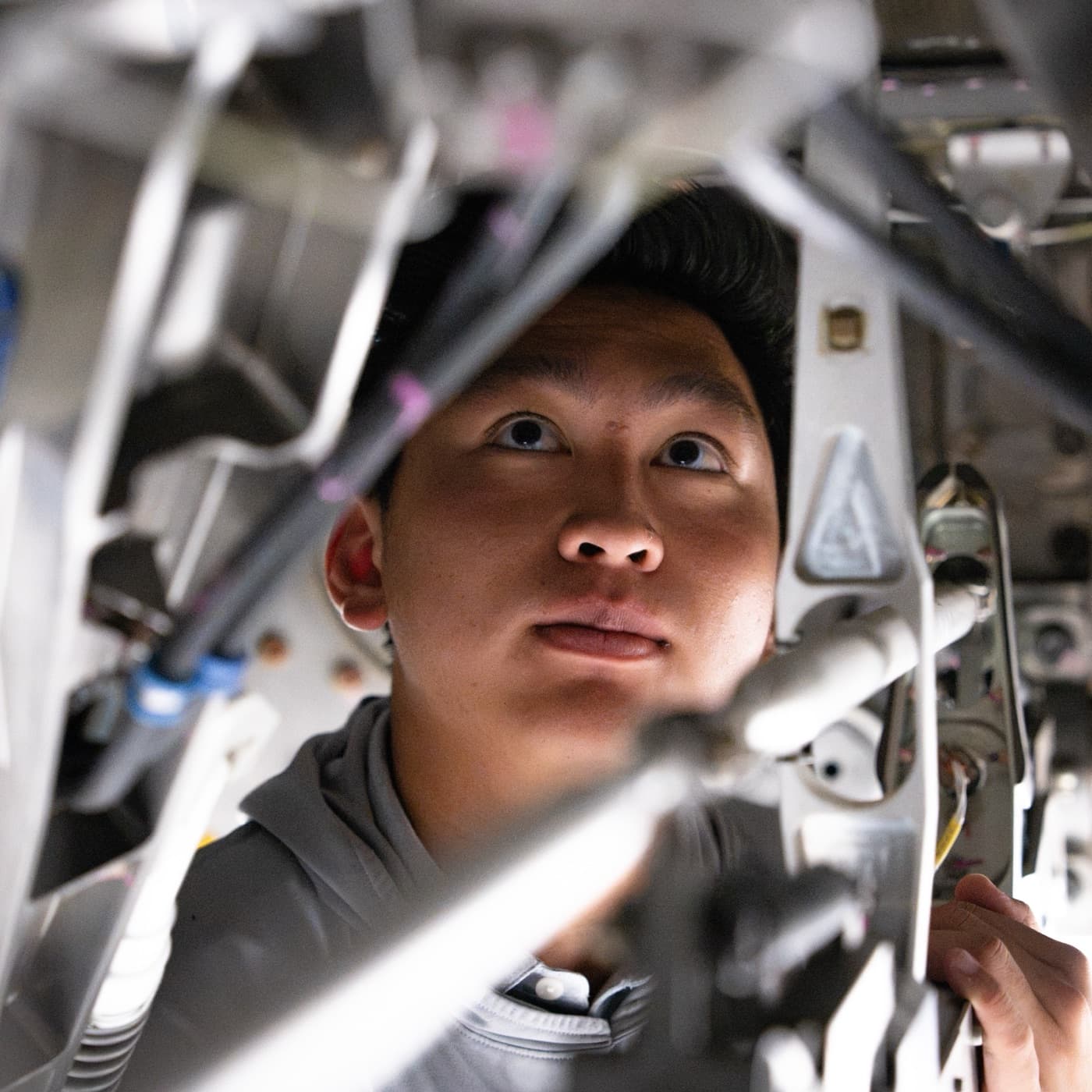 An engineer inspecting aircraft structure up close