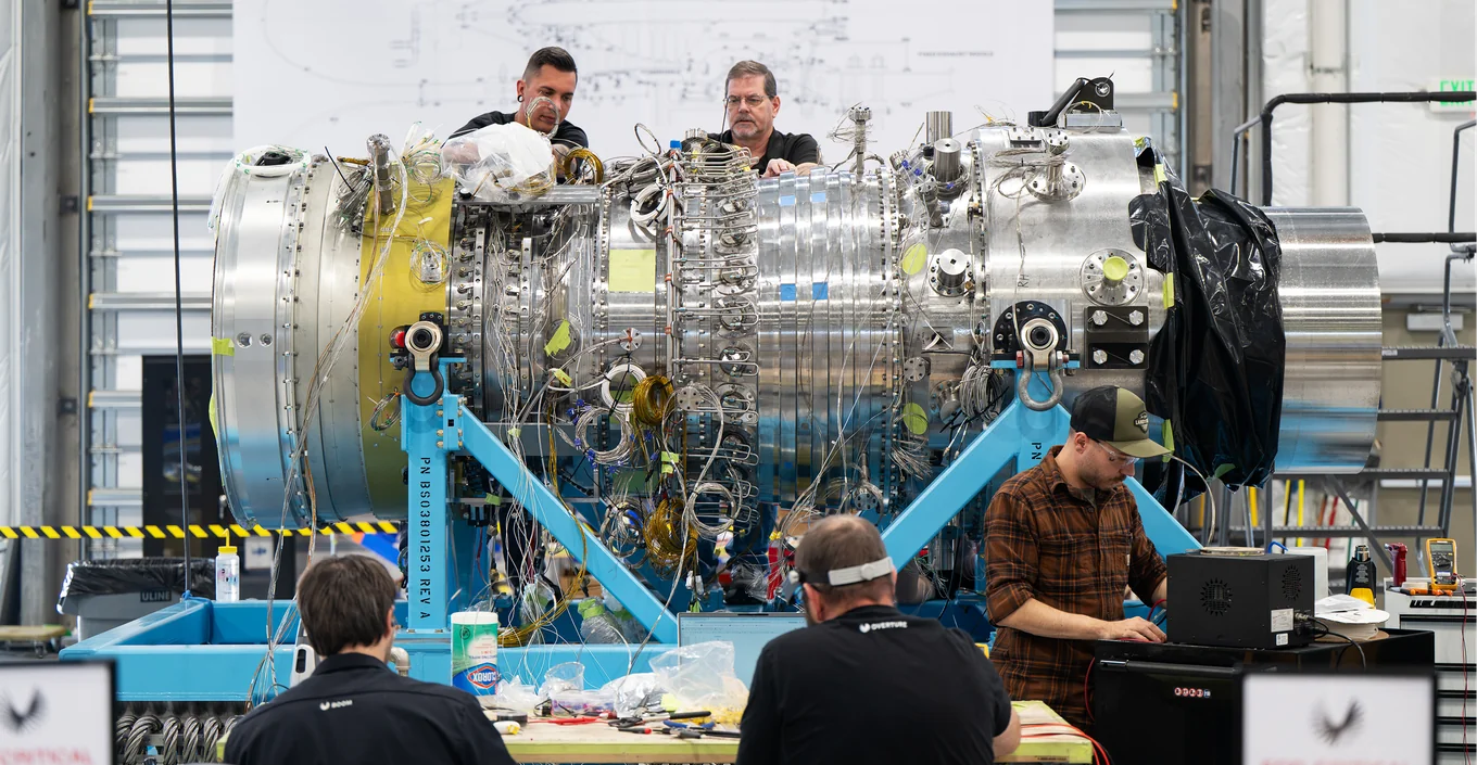 Boom team members working around a turbine on the factory floor