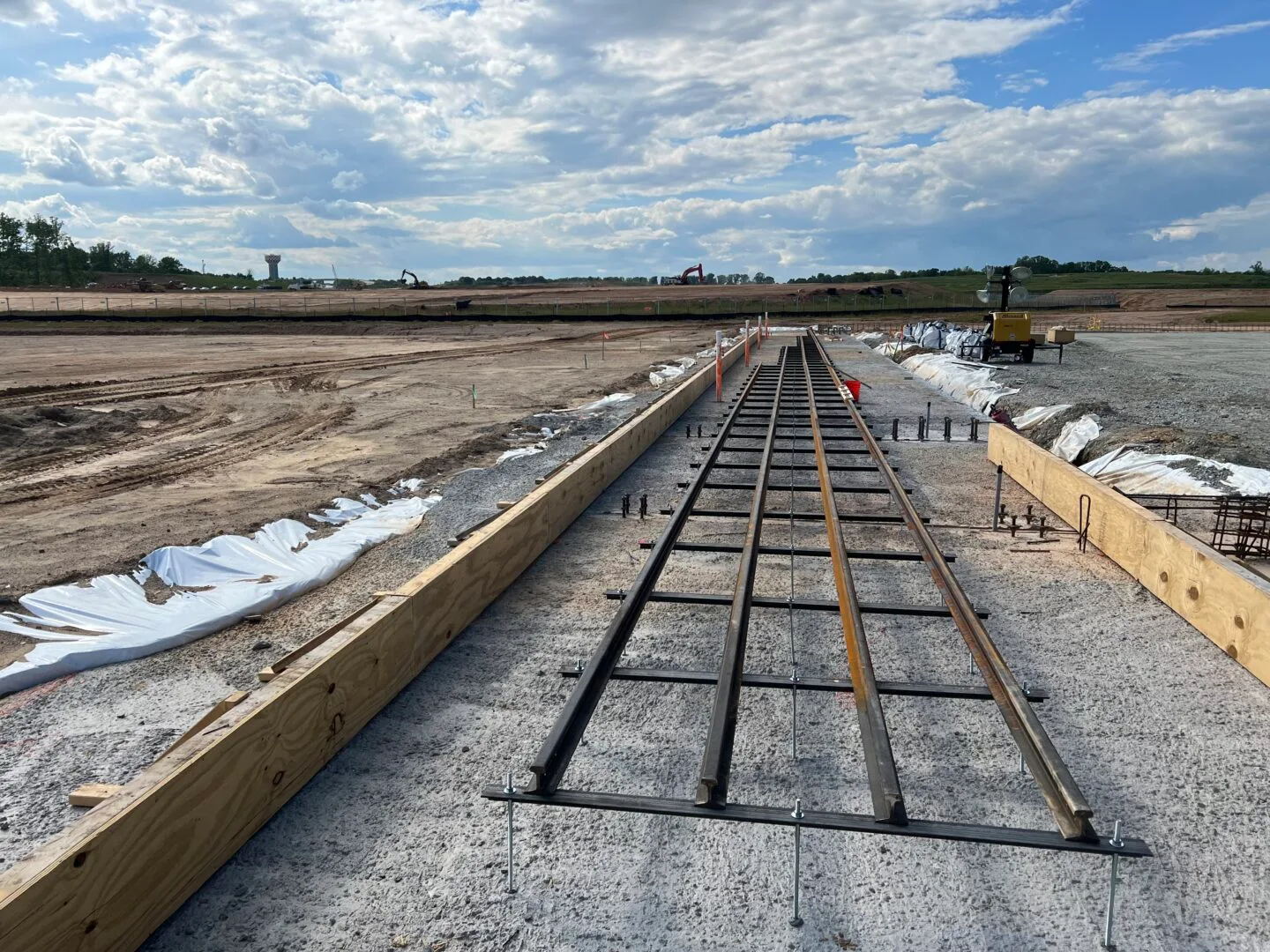 May 2023: Foundation rails are placed for the Boom Supersonic Superfactory. 