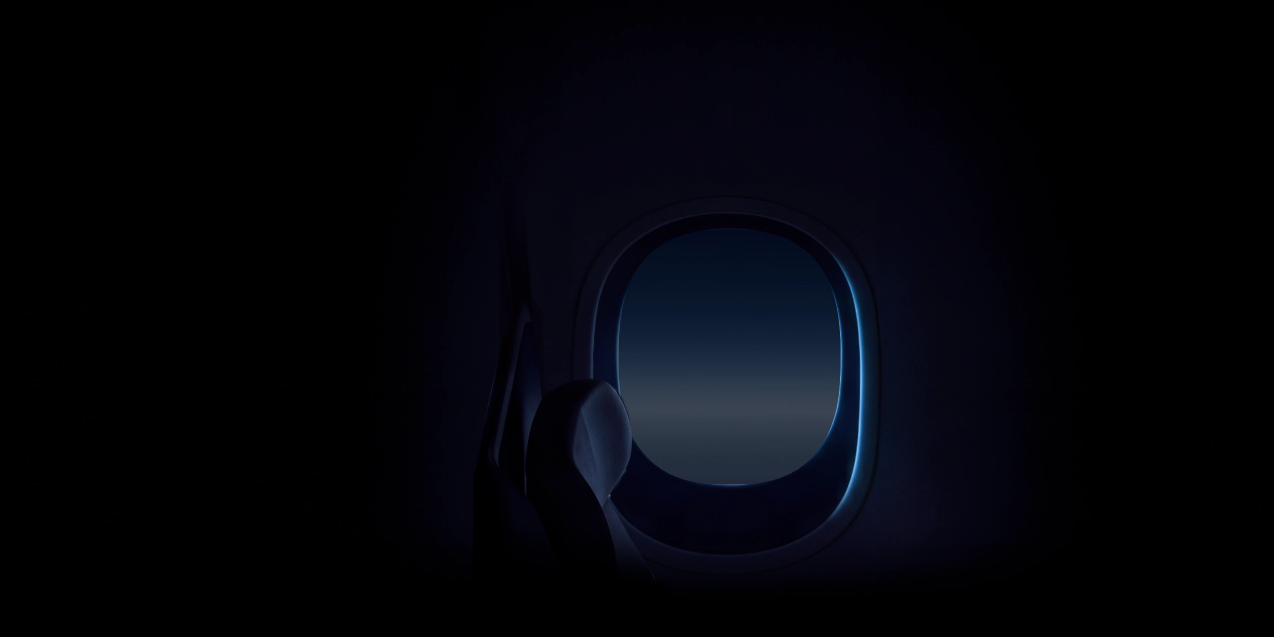 An aircraft window edged in blue light in a darkened cabin, beside a seat