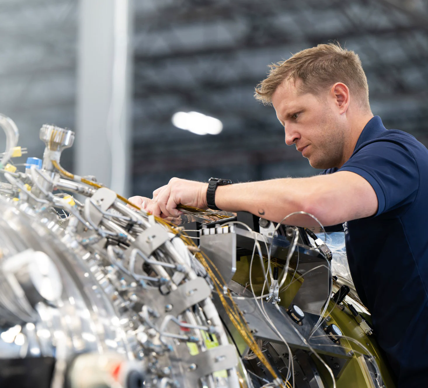 A Boom technician routing wiring on the assembled turbine