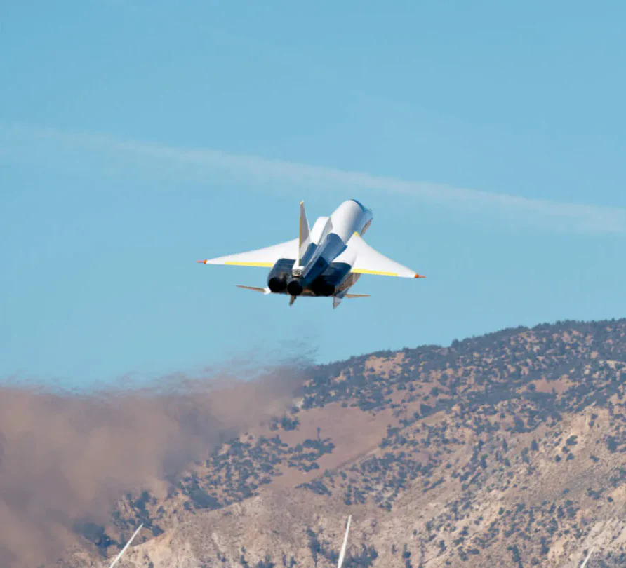XB-1 climbing away from the runway over the Mojave hills
