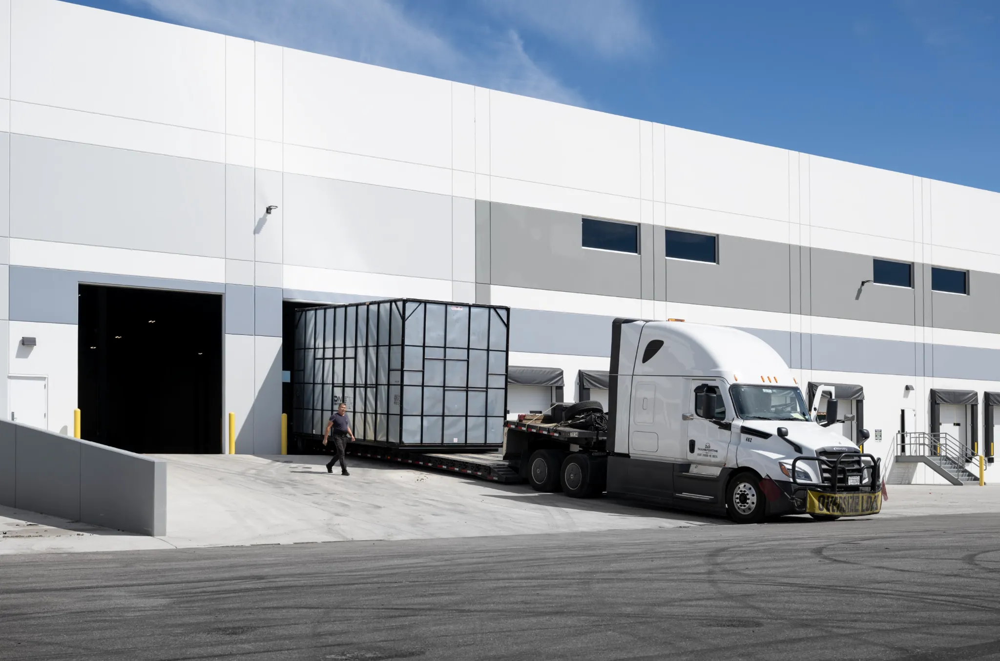 A truck delivering a turbine frame to the loading dock of the Superpower Superfactory