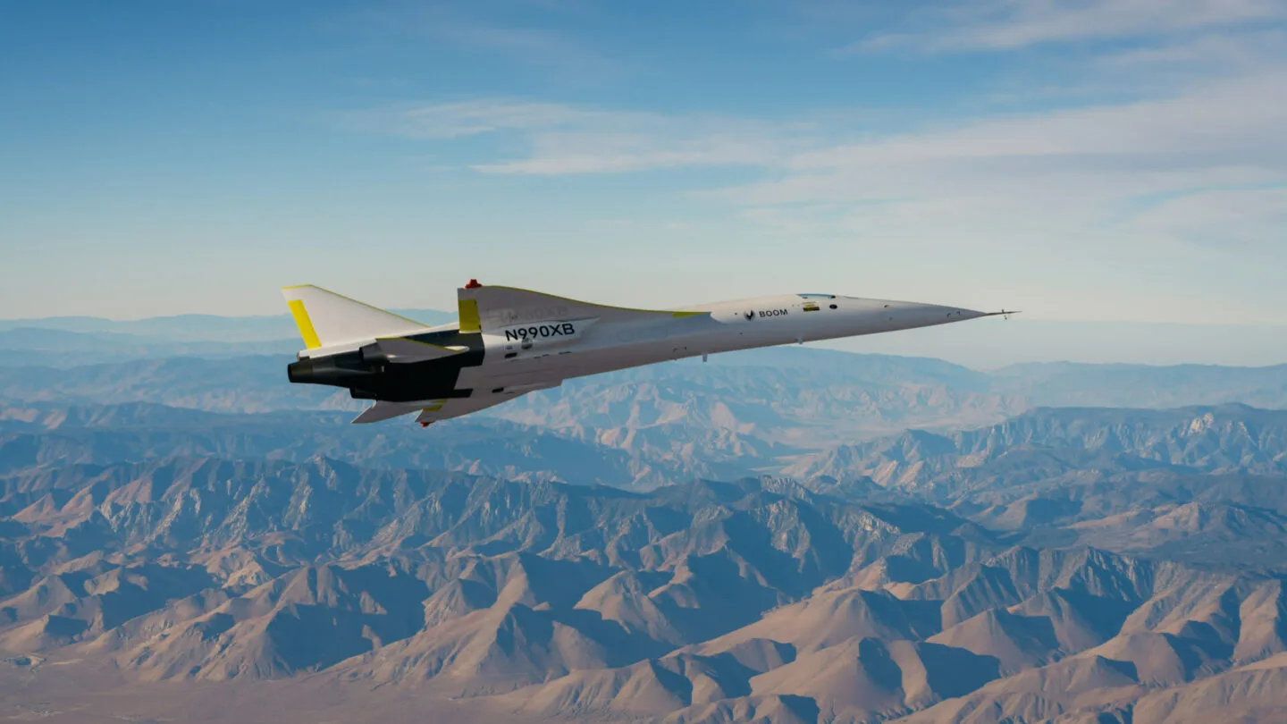 XB-1 banking above desert mountains, seen from below